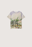 A short-sleeve crewneck t-shirt featuring a watercolor landscape print on the front and solid lavender purple raglan sleeves, displayed flat against a light gray background.